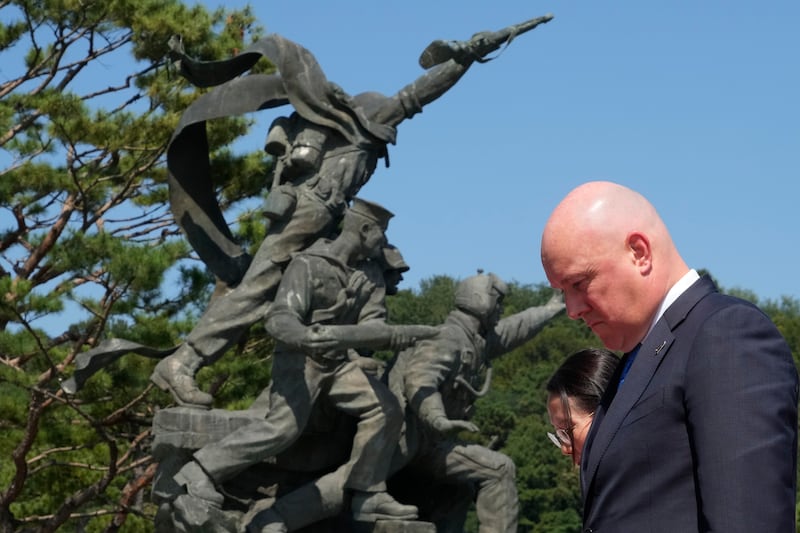 Mr Luxon paid a silent tribute during a visit to National Cemetery in Seoul (AP)