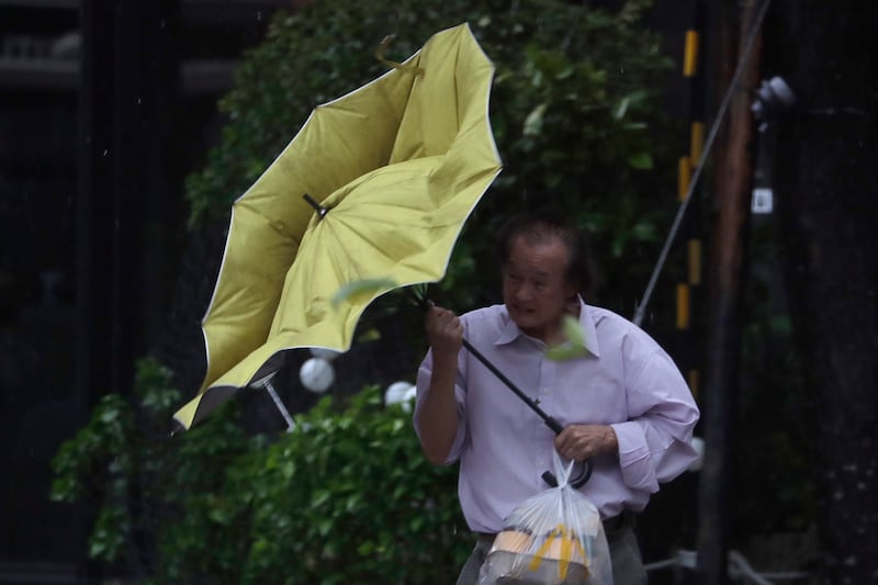 A man struggles with his umbrella against gusts of wind generated by Typhoon Kong-rey in Taipei, Taiwan (Chiang Ying-ying/AP)