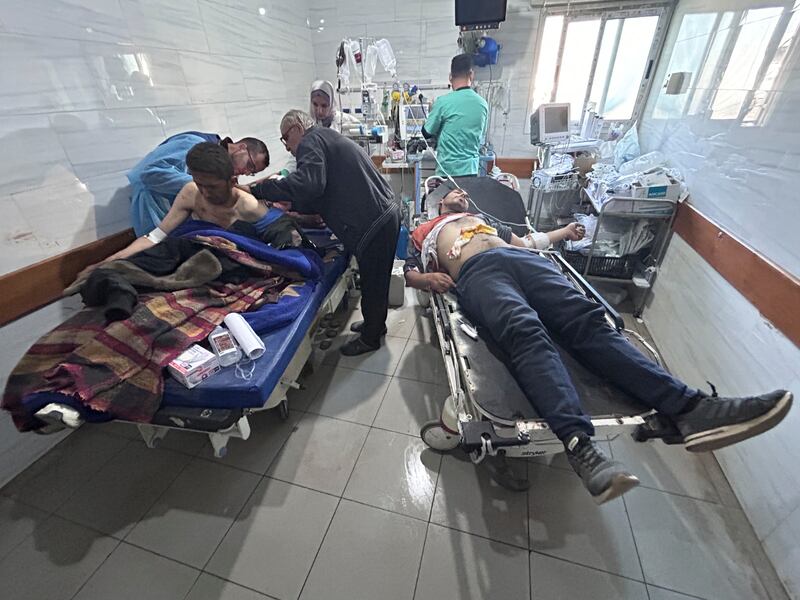 Palestinians injured in an Israeli strike are treated in Shifa Hospital in Gaza City (Mahmoud Essa/AP)