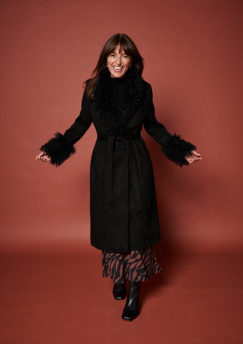 Davina McCall wears Joe Browns Black Fur Trim Coat; Black High Neck Embellished Long Sleeve Top;  Nobody's Child Mila Midi Skirt; Square Toe Leather Boots