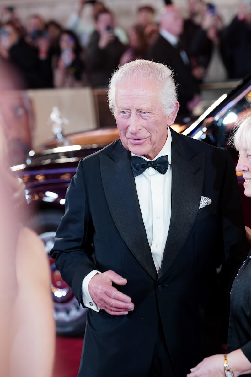 The King wore a black tuxedo and matching bow tie