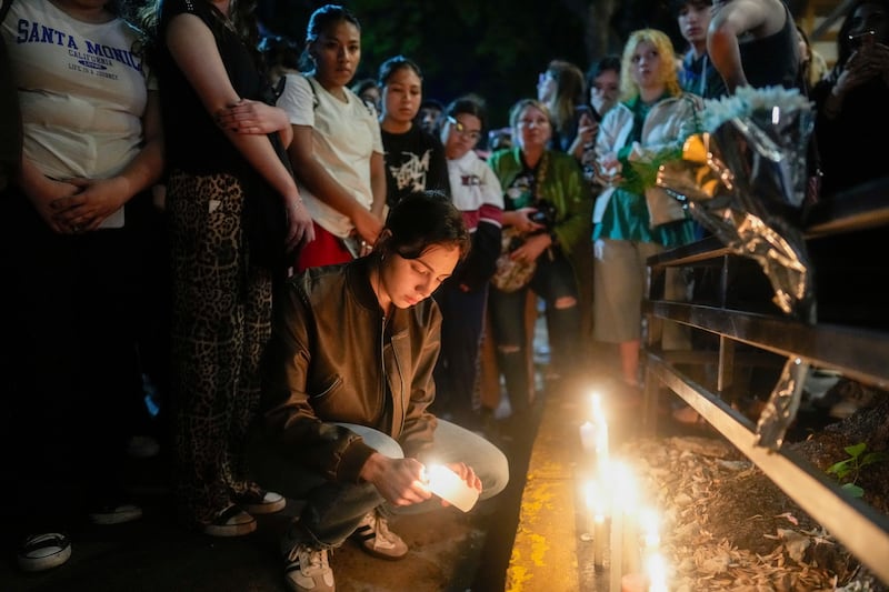 Fans light candles outside the hotel where former One Direction singer Liam Payne died (Natacha Pisarenko/AP)