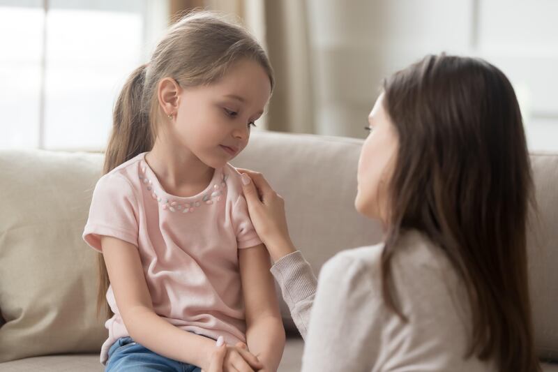 Loving mom talking to upset daughter and giving support