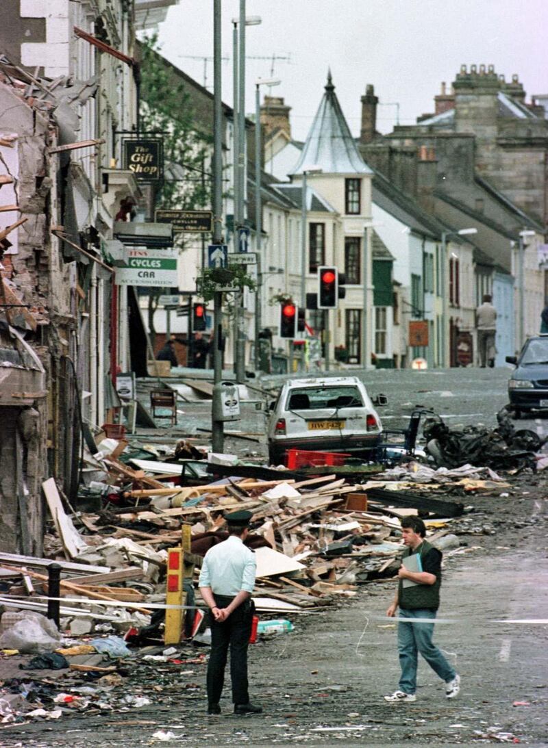 Police officers and firefighters inspecting the damage caused by the bomb explosion in Market Street, Omagh, in 1998