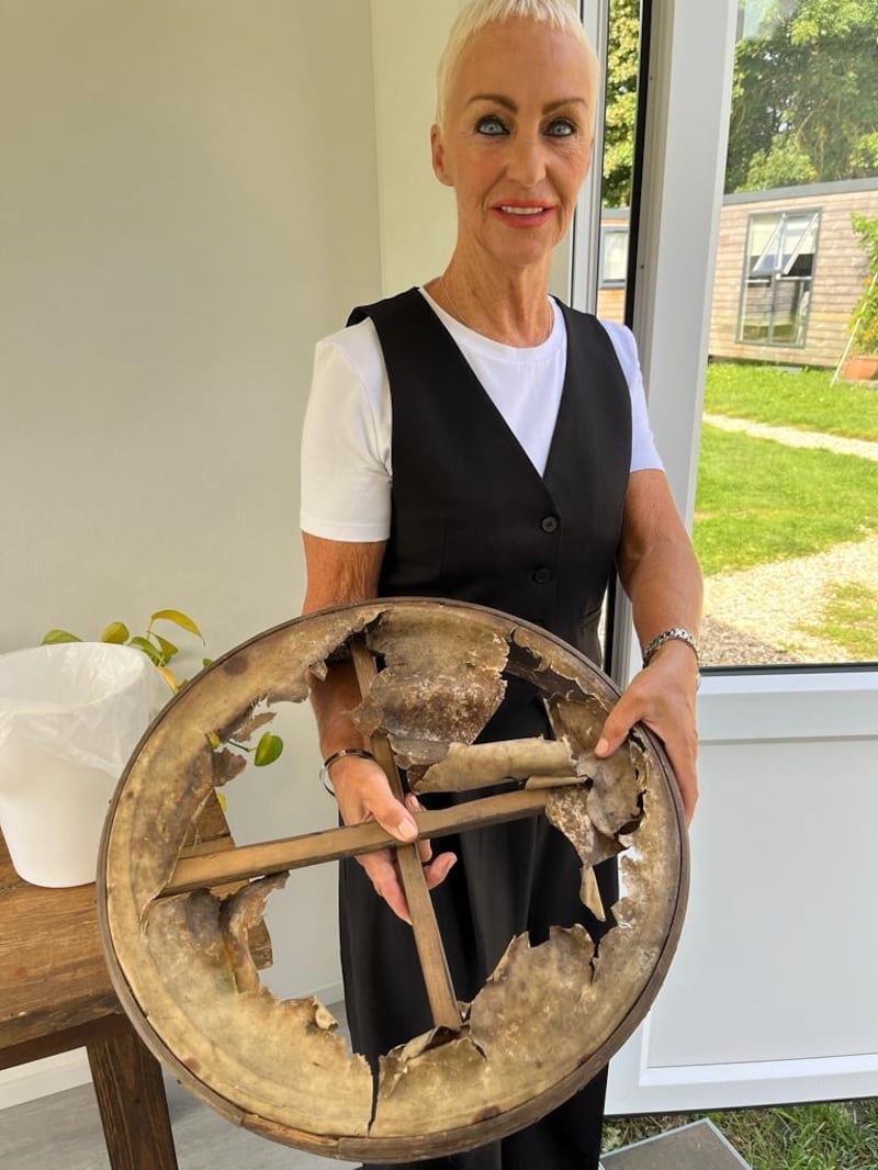 Catherine Bradley with the bodhrán made by her brother Seamus McGuinness before its restoration by The Repair Shop's instrument expert, Pete Woods.
