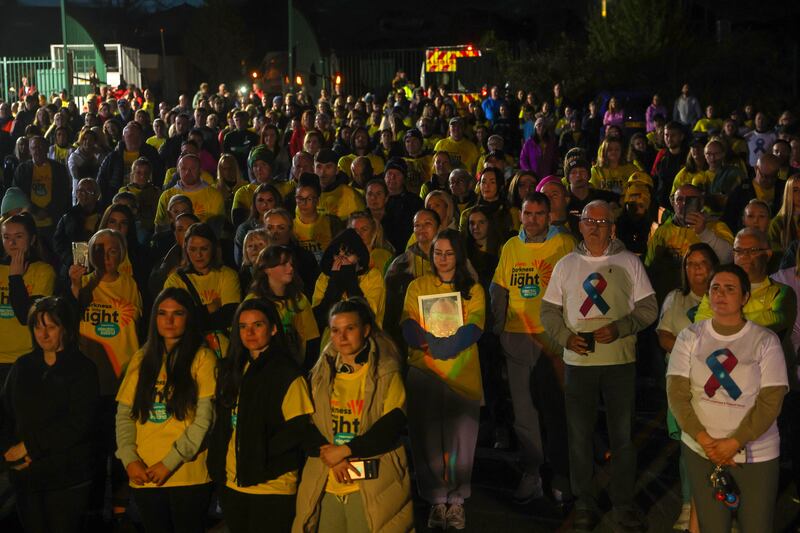 Family and friends take part into The Darkness Into Light 5k walk in memory of those who died by suicide from the Lamh Dhearg GAA club in west Belfast. PICTURE: MAL MCCANN