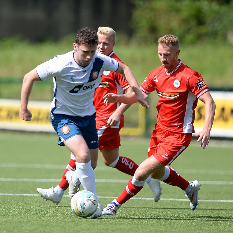 Cliftonville defensive debutant Michael Newberry closes down Portadown's Shay McCartan at Solitude.