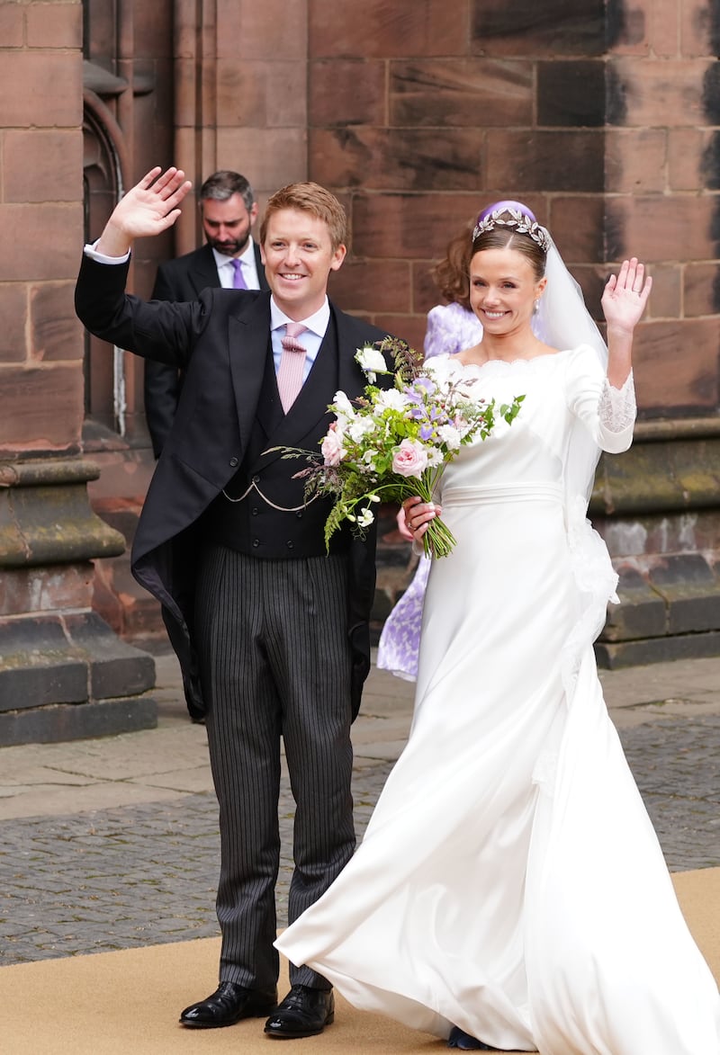 Olivia Henson and Hugh Grosvenor, the Duke of Westminster waving to the crowds on leaving Chester Cathedral after their wedding ceremony