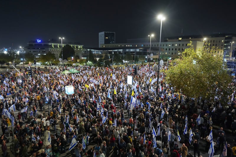 People protest against Prime Minister Benjamin Netanyahu after he dismissed defence minister Yoav Gallant (Ohad Zwigenberg/AP)