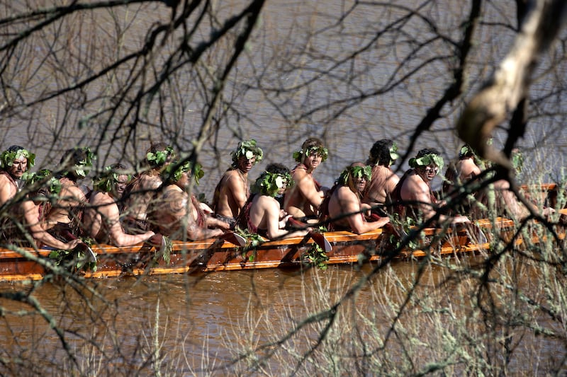 A waka, a traditional canoe, is paddled by warriors on the Waikato River as part of the funeral of New Zealand’s Maori King (Alan Gibson/AP)