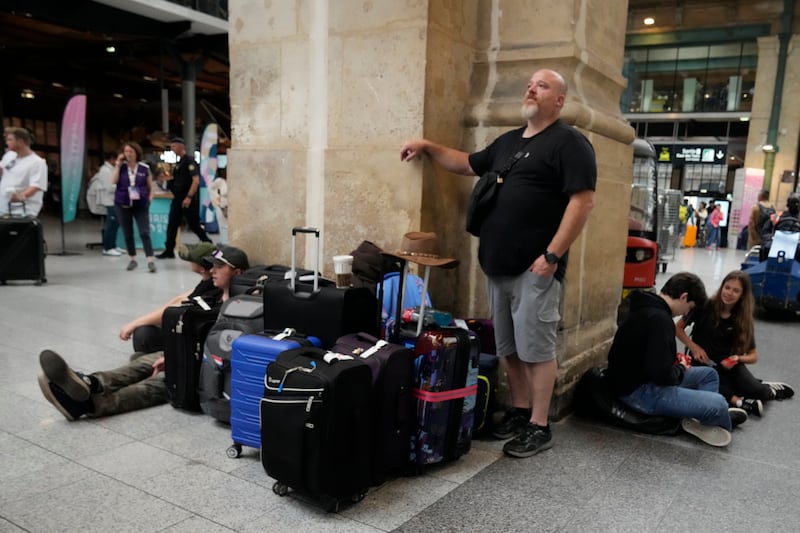 Passengers wait at the Gare du Nord station (Mark Baker/AP)