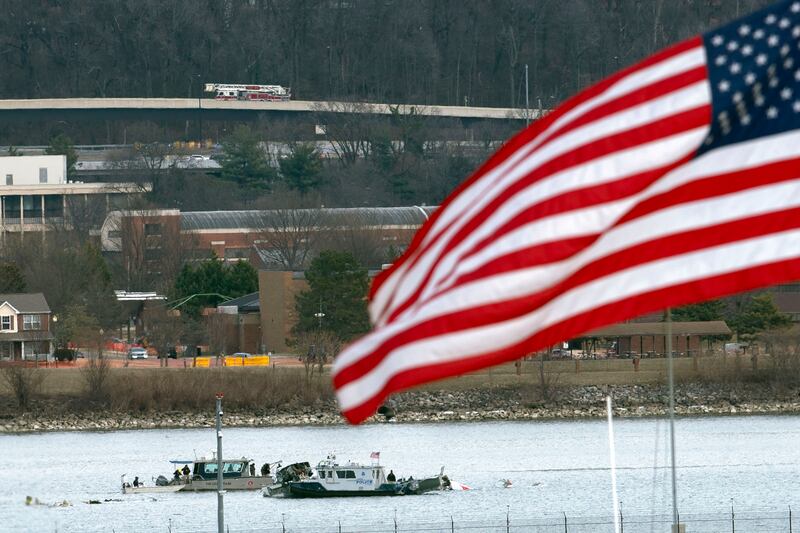 A diving team and police boat is seen around a wreckage site in the Potomac River (Jose Luis Magana/AP)