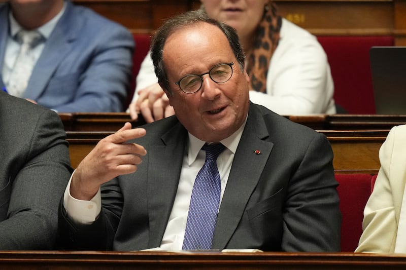 Former French president Francois Hollande gestures as he listens to French Prime Minister Francois Bayrou at the National Assembly in Paris (Thibault Camus/AP)