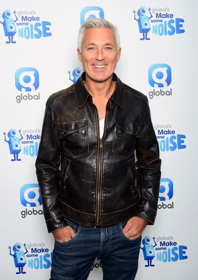 Martin Kemp smiling, with his hands in his pockets.