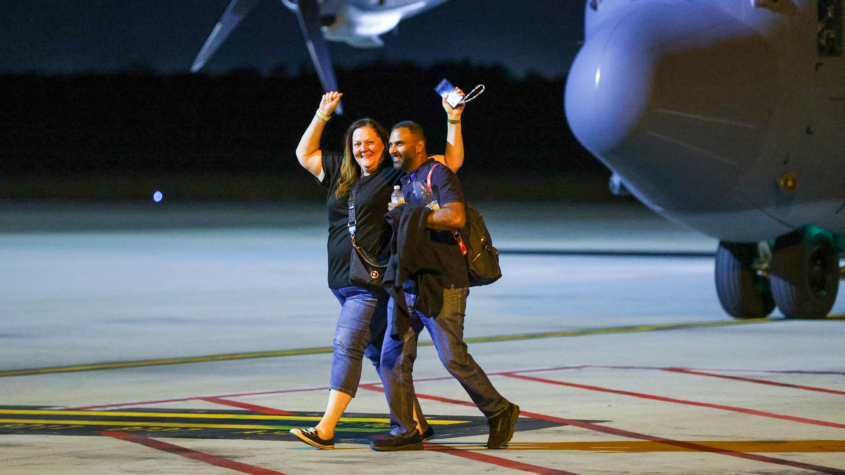 Repatriated Australian travelers react as they arrive from New Caledonia to Brisbane International Airport (David Clark/AP)