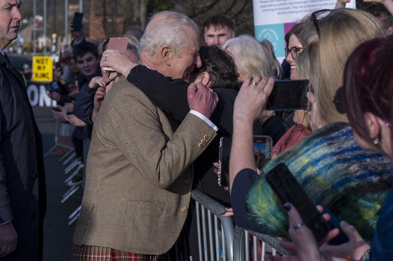 The King received a hug from one well-wisher during his walkabout