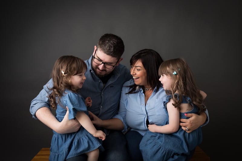 Charlotte Nicholas pictured with her late husband Gavin and their daughters Olivia and Lilah. PICTURE: CANCER FOCUS NI