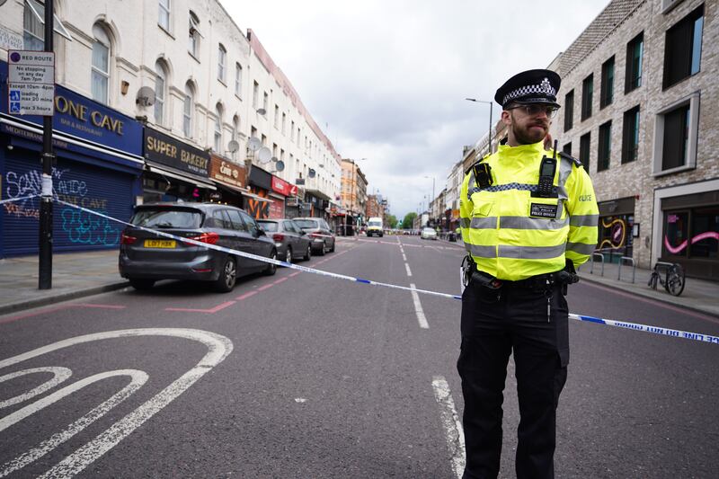 A police officer stands at the scene of the incident