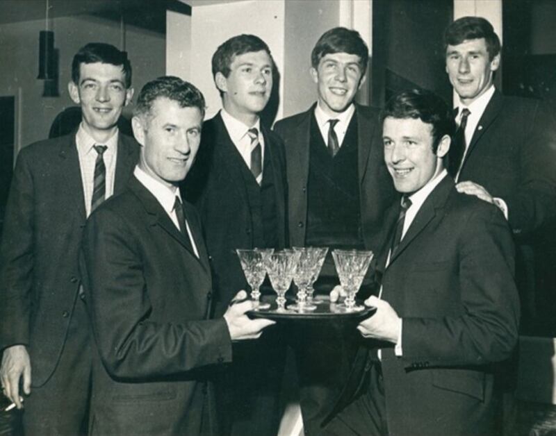 Jim McKeever being presented with a set of Waterford Glass tumblers by his captain Paddy Diamond at an end-of-year dinner in May 1969. Also pictured are (back, l-r) Donal Magee (selector), Malachy McAfee (chairman), Gerry Regan (secretary) and Ray McConville (treasurer)