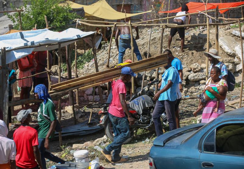 Residents of the Nazon neighbourhood displaced by gang violence construct a tent encampment in Port-au-Prince, Haiti (Odelyn Joseph/AP)