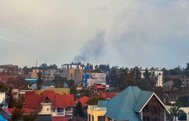 Smoke rises over Goma as M23 rebels make their way to the centre of the town (Moses Sawasawa/AP)