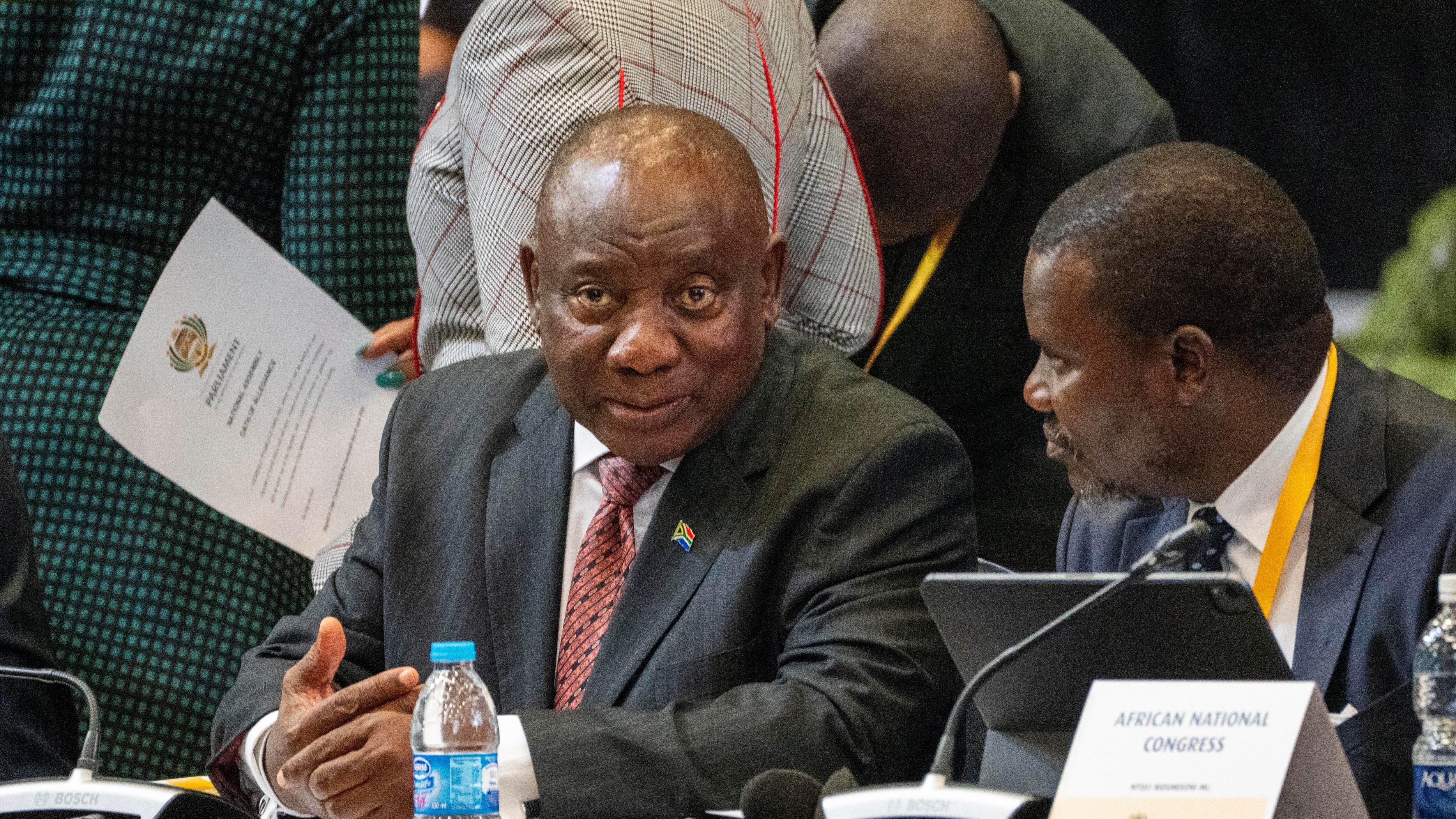 Cyril Ramaphosa listens as members of parliament are sworn in ahead of an expected vote to decide if he is re-elected as leader of the country (Jerome Delay/AP)
