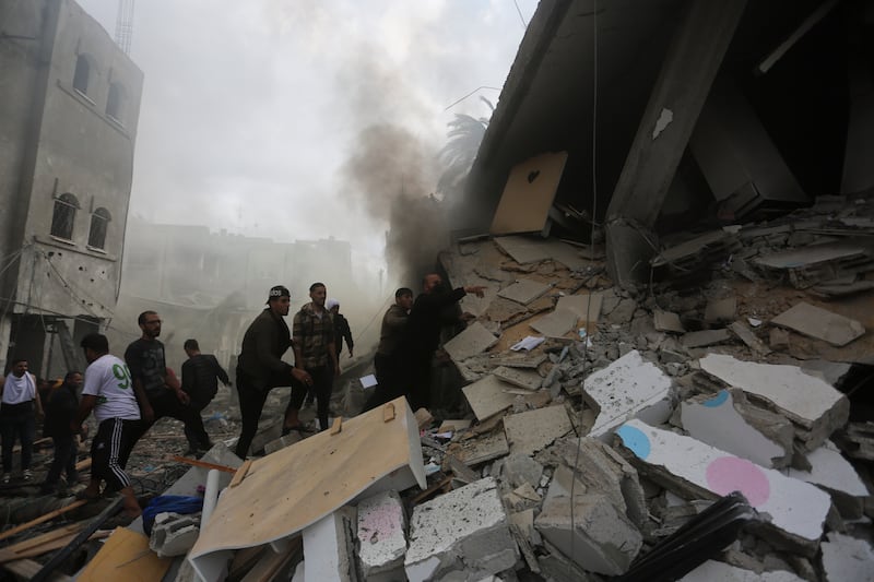 Palestinians look for the survivors of an Israeli strike in Rafah, Gaza Strip (Hatem Ali/AP)