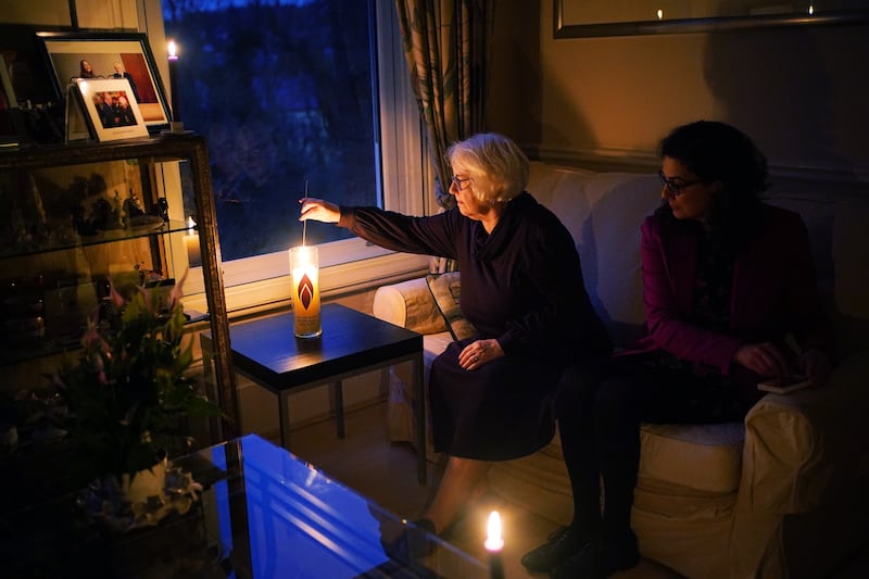 Mrs Salter lights a memorial candle at her home