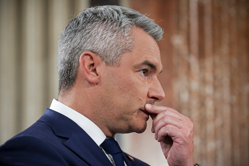 Austrian Chancellor Karl Nehammer gestures at the national broadcaster studio, set up in the parliament building, in Vienna after polls closed. (AP Photo/Heinz-Peter Bader)