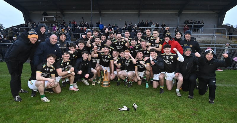 The Dungannon squad celebrate with the Brendan Dolan Cup after the Tyrone League Division One League final at Augher. Picture Oliver McVeigh