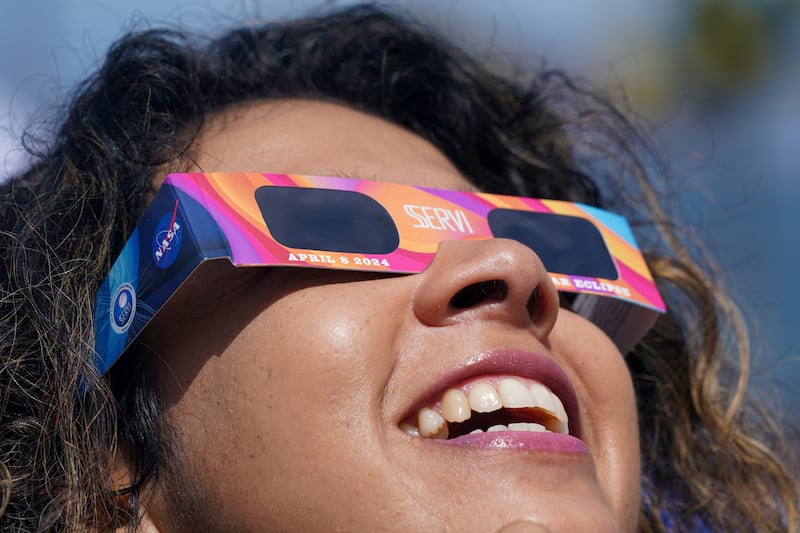 A woman wears special glasses to watch the eclipse in Mazatlan, Mexico (Fernando Llano/AP)