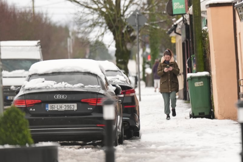 A woman makes her way along a snow covered pavement in Ballylynan in Co Laois. PICTURE: NIALL CARSON/PA Wire