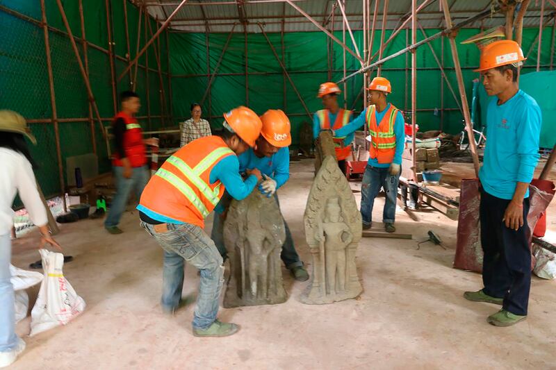 Statues being arranged at Angkor Thom (Phouk Chea/Apsaras National Authority via AP)