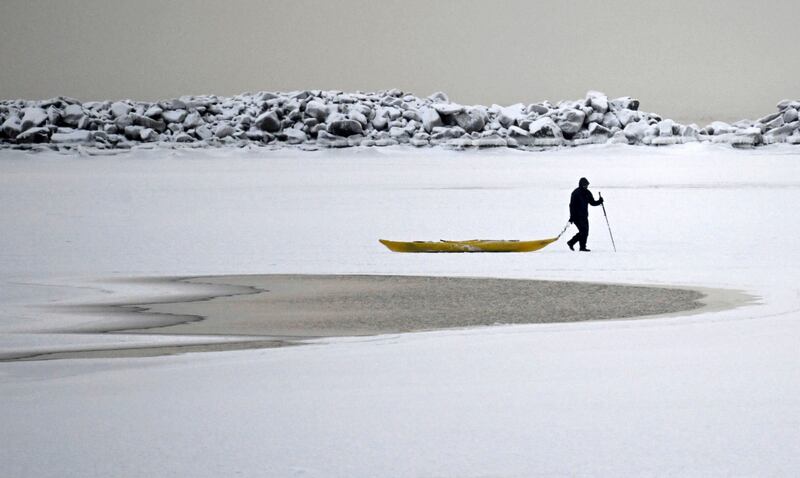 A man walks on the frozen sea in southern Helsinki (Vesa Moilanen/Lehtikuva via AP)