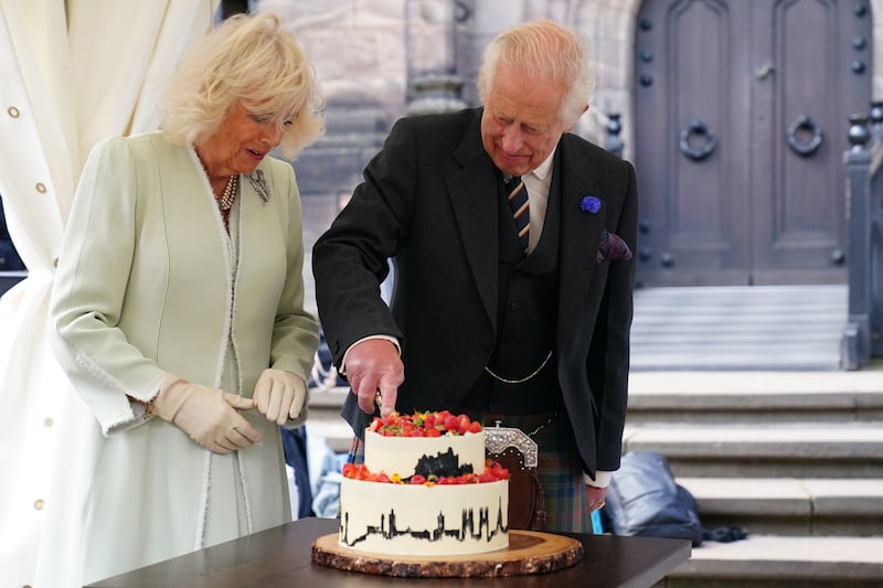 The King and Queen cut a cake made by 2020 Great British Bake Off winner Peter Sawkins