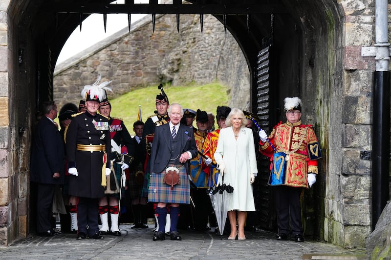 The governor of Edinburgh Castle Major General Alastair Bruce (left) and Lord Lyon (right) with the King and Queen