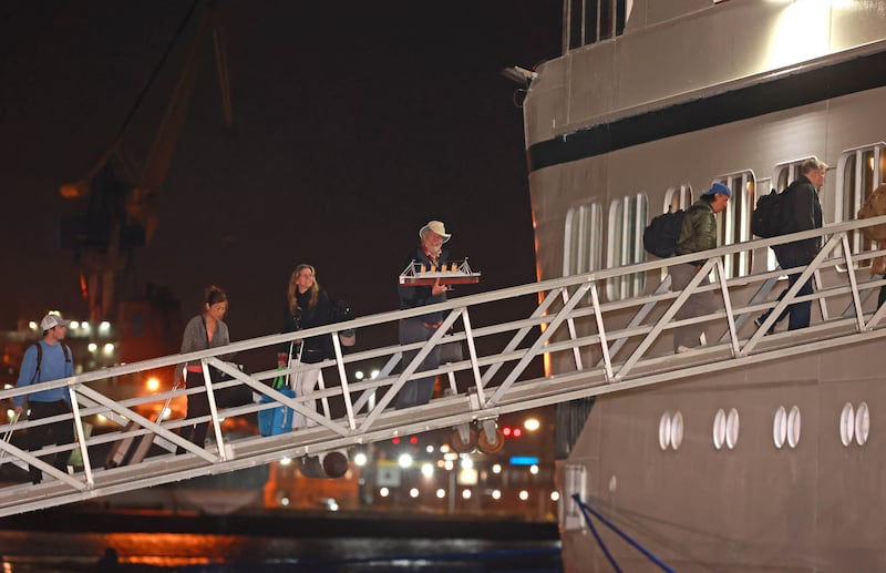 Passengers board the cruise ship Villa Vie Odyssey at the cruise ship terminal in Belfast Port after the luxury cruise ship was stranded in Belfast for four months due to unexpected repair work.