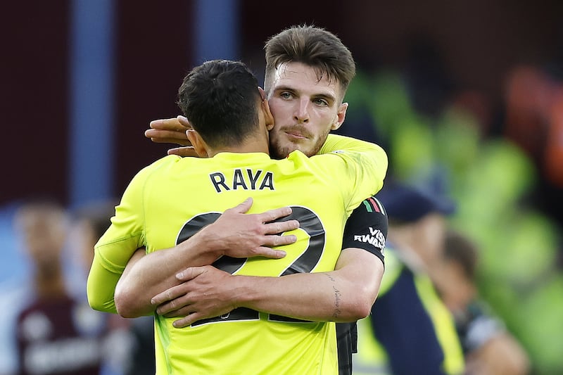 Arsenal goalkeeper David Raya, left, is embraced by Declan Rice at full-time