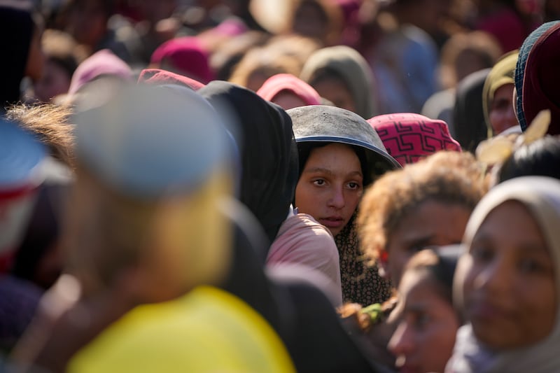 Palestinian children wait in line for food at a distribution centre in Deir al-Balah, Gaza Strip (Abdel Kareem Hana/AP)