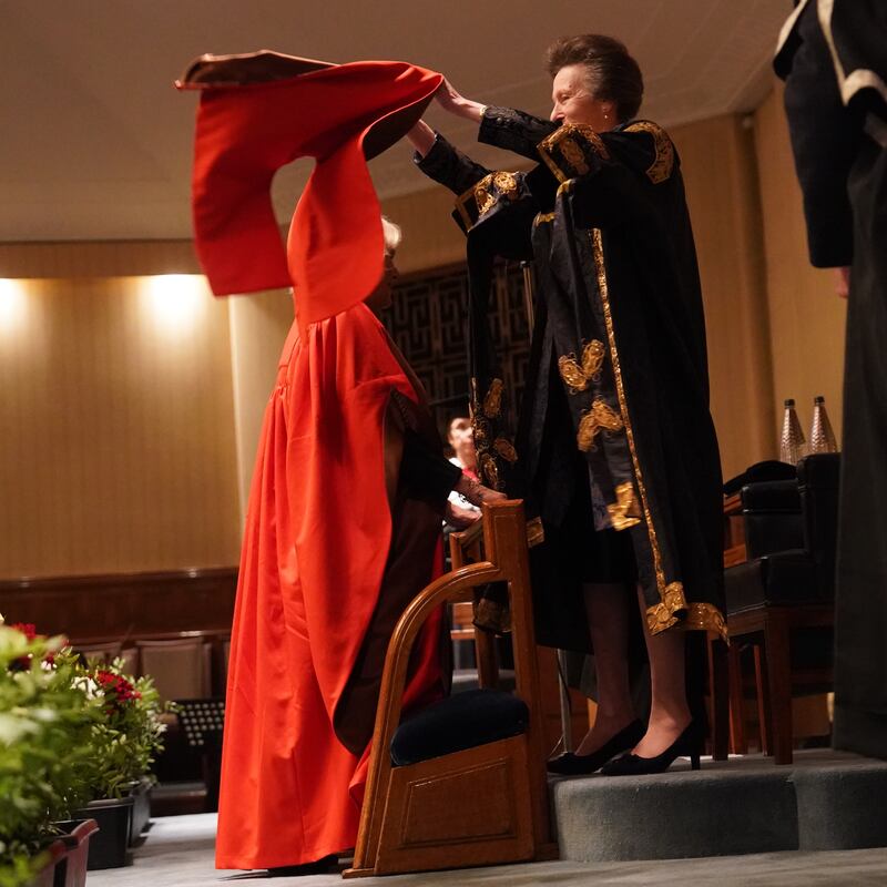 The Princess Royal placed a hood over her sister-in-law’s hair