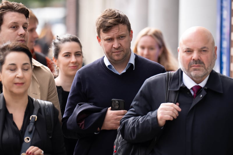 Scott Law (centre) has pleaded not guilty to a charge of common assault