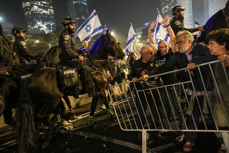 Israeli police try to push back protesters from a main road in Tel Aviv (Oded Balilty/AP)