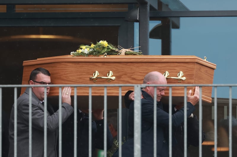 The coffin of Ms Aust is carried from the church