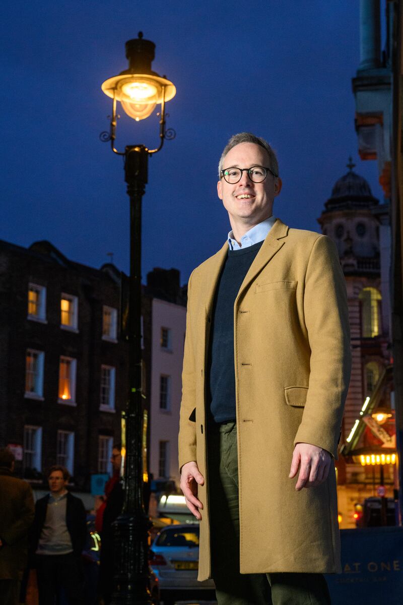 Arts and Heritage minister Lord Parkinson poses next to one of the lamps