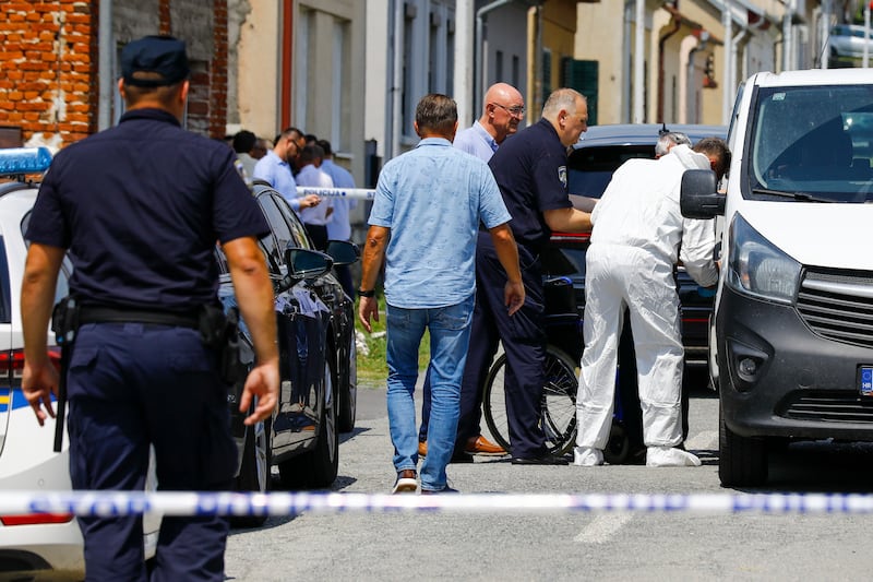 Police and forensic officers gather near the crime scene in Daruvar (Zeljko Puhovski/Cropix/AP)