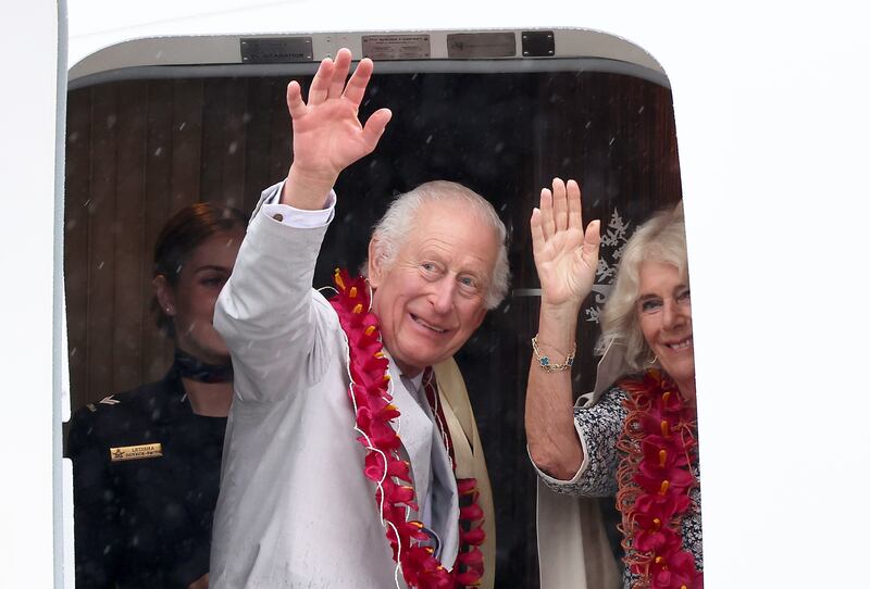 The King and Queen wave as they board an Royal Australian Air Force plane in Samoa at the end of their tour