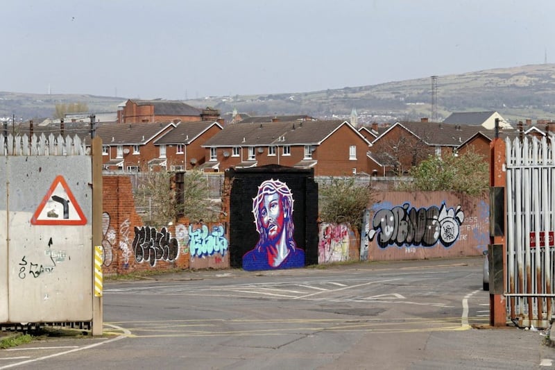 Street artist Glen Molloy paints a picture of Jesus on the Peaceline near Cupar Way, it is done in the style of the iconic &quot;Hope&quot; image of Barack Obama designed by artist Shepard Fairey Picture Mal McCann. 