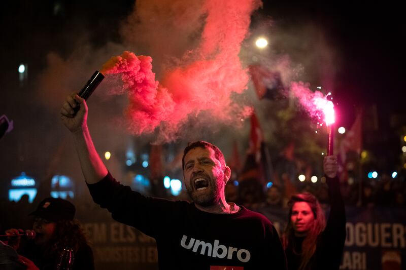 Demonstrators light flares while marching in a protest against the exorbitant rise in the price of renting an apartment in Barcelona (Emilio Morenatti/AP)