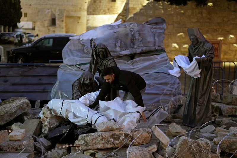 Rubble and barbed wire was used to decorate the nativity scene in Bethlehem (AP)