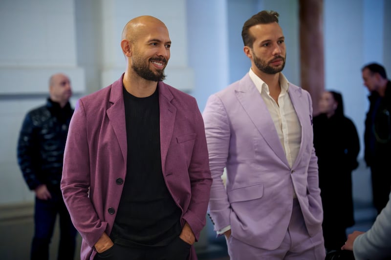 Andrew Tate, left, smiles next to his brother Tristan, right, at the Court of Appeals building in Bucharest (Vadim Ghirda/AP)